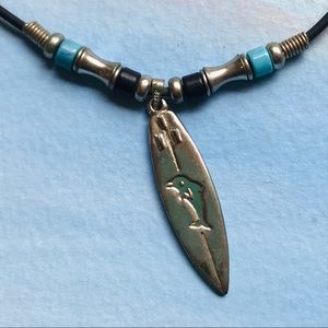 Necklace with surfboard and turtle, abalone accents black cord w/ beads. Unisex